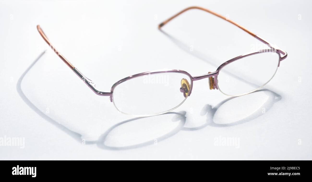 longsighted prescription glasses with shadow arranging on white background Stock Photo