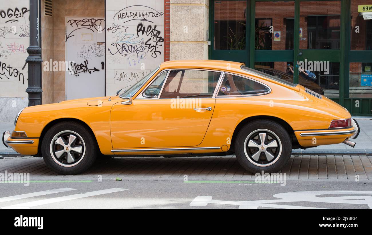 Madrid, Spain; 04172022: Luxury car parked on the street. Bright orange. Stock Photo