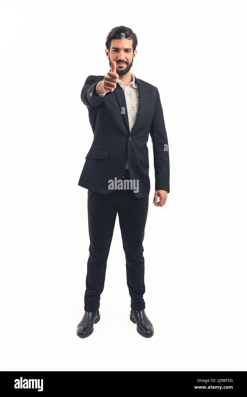 young latin businessman in black classic suit stands looking away. High quality photo Stock Photo