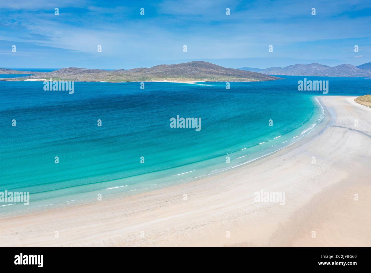 Not a soul in sight as aquamarine waters lap against this perfect white beach. Stock Photo