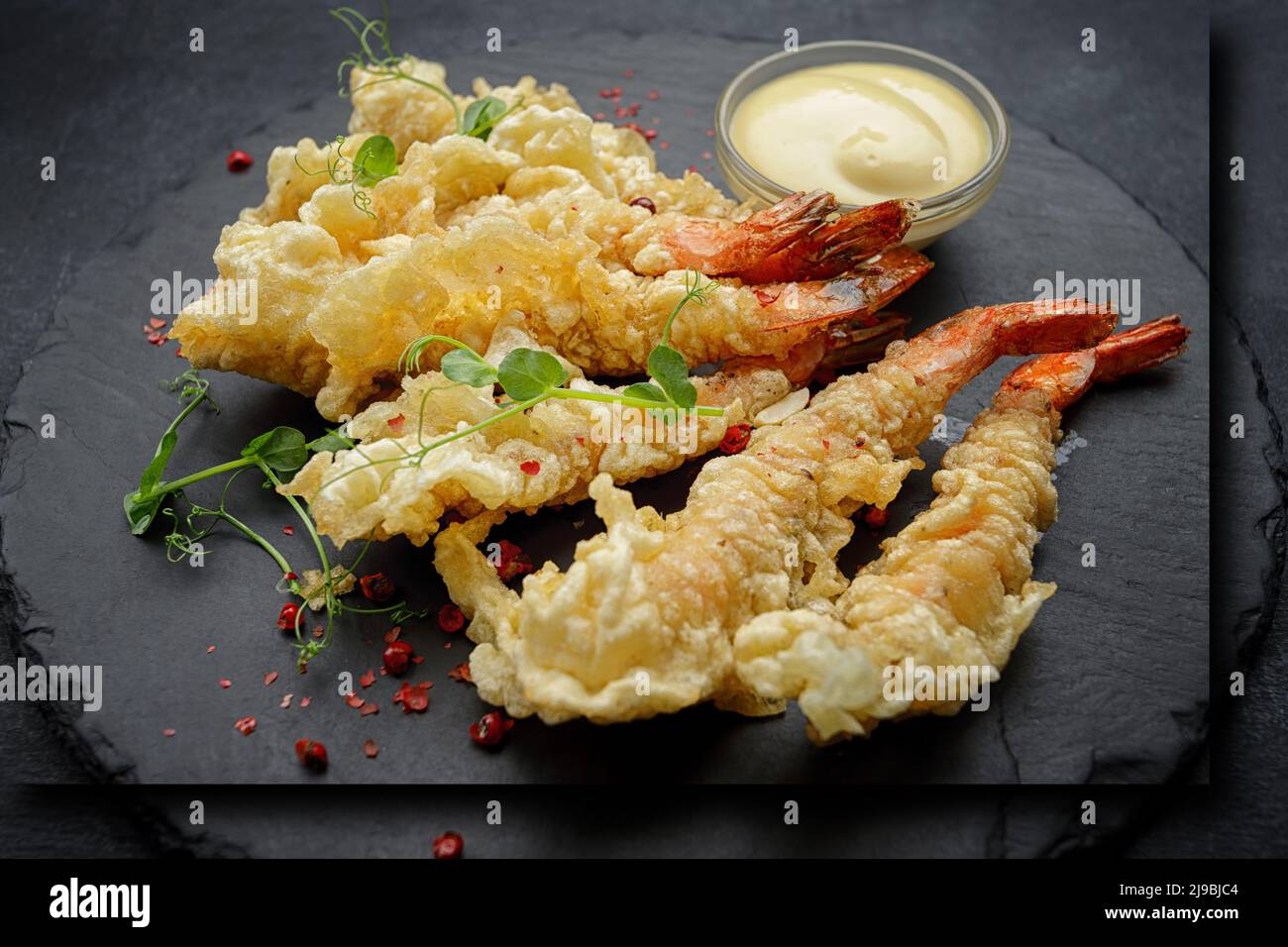 Tempura shrimps with sauce, on a dark background Stock Photo