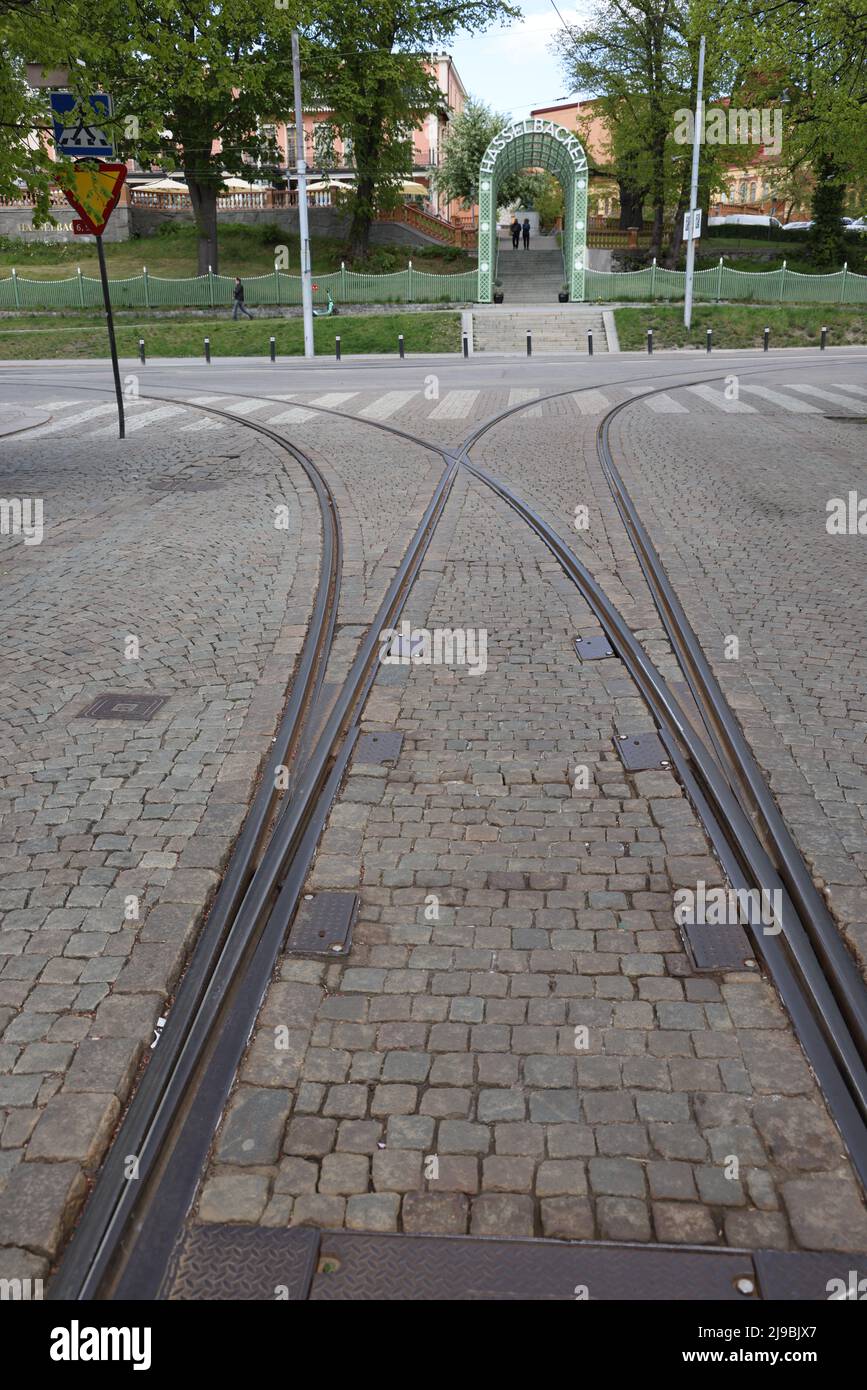 Bifurcation (fork, railroad switch) in tram tracks in Stockholm, illustrating concepts of choice of direction or a split or separation of ways Stock Photo