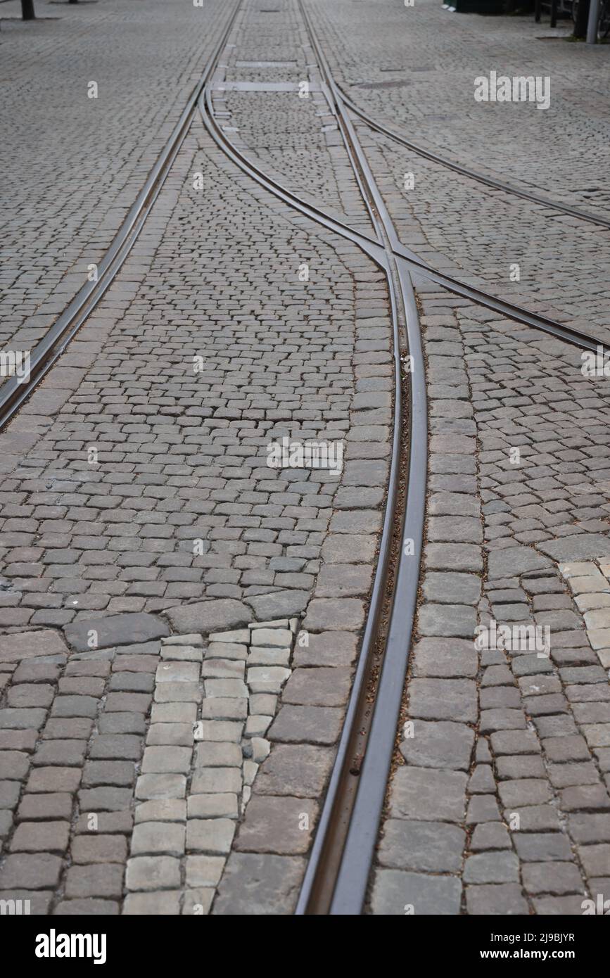 Joining of tram rails / tracks coming together in Stockholm, illustrating concepts coming together, aligning, alignment, joining, becoming one Stock Photo