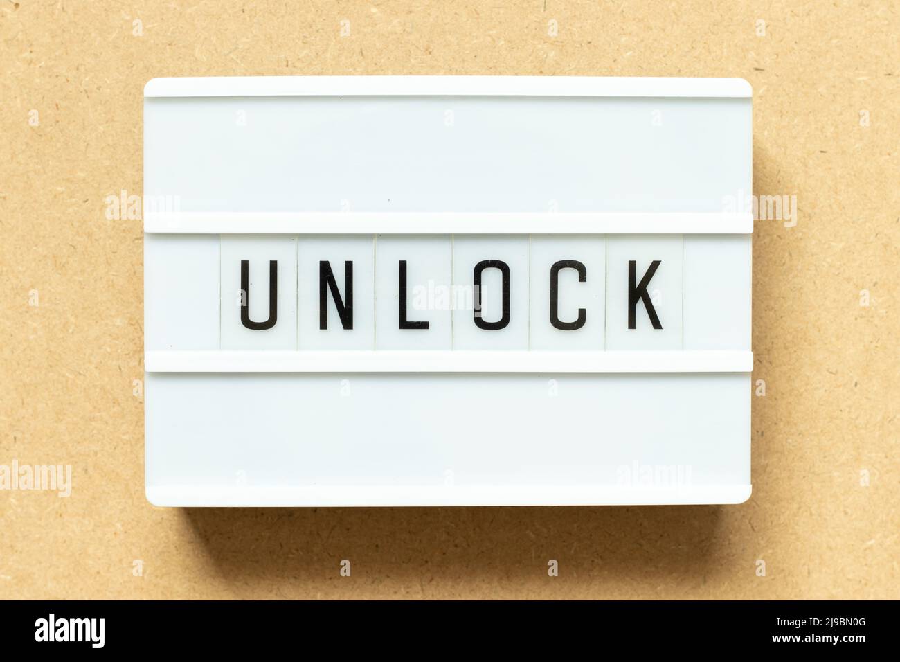 Lightbox with word unlock on wood background Stock Photo