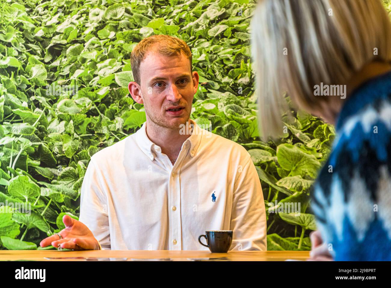 Nordic Wasabi marketing chief Olli Hall in front of the photo wall of the first wasabi