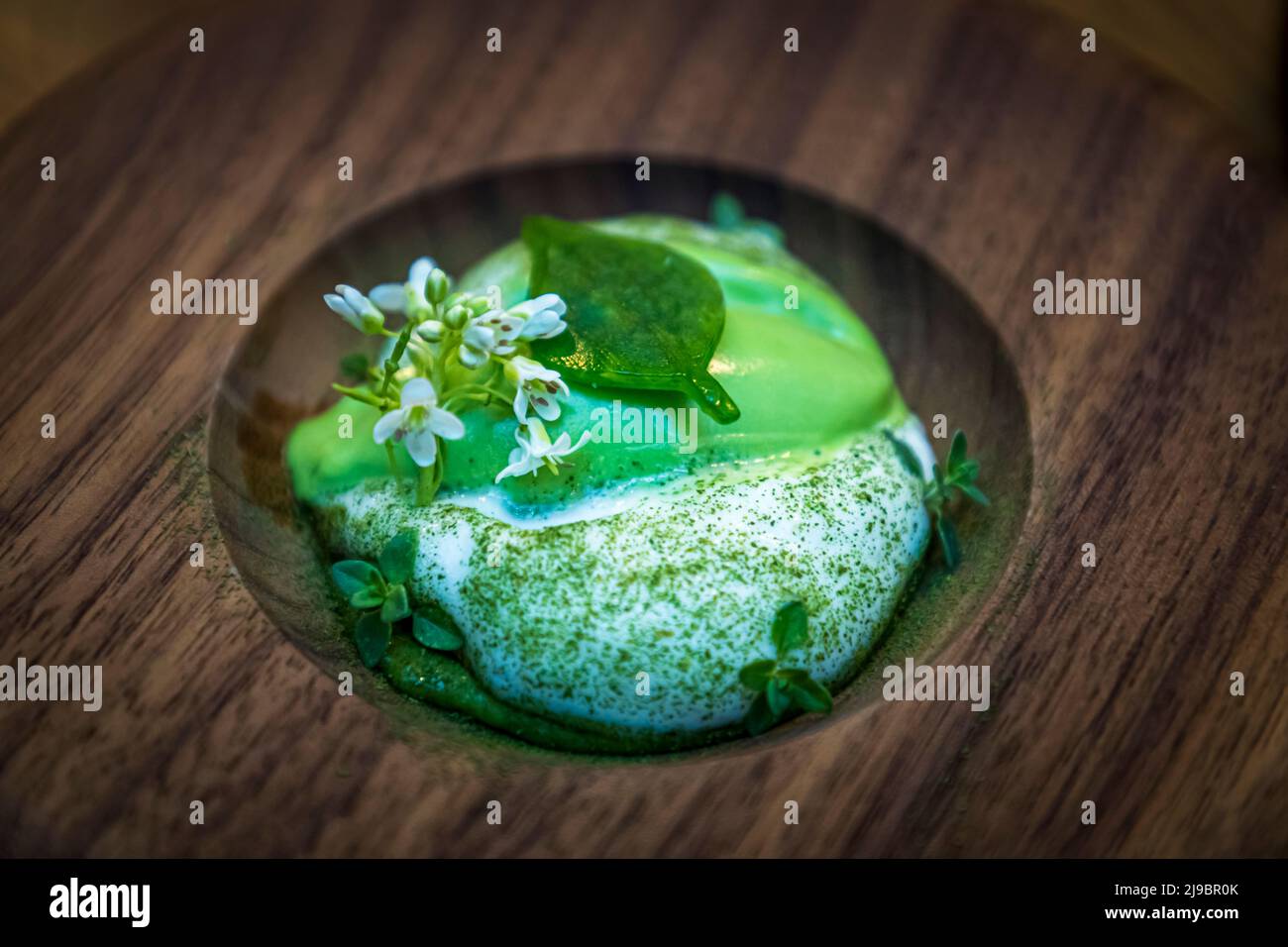 Top chef Runar Pierre from Öx restaurant in Reykjavik preparing a dessert with wasabi. He uses not only the wasabi stem but also the leaves and flowers Stock Photo