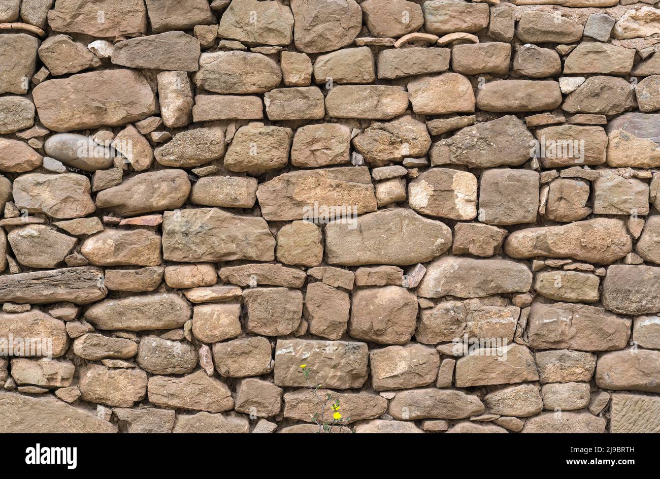 Old stone wall stones fitted together without cement, carved by hand