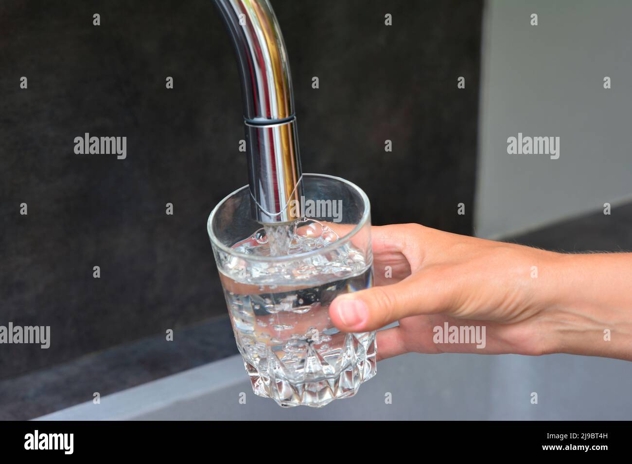 Female hands pouring water in glass cup Stock Photo Alamy