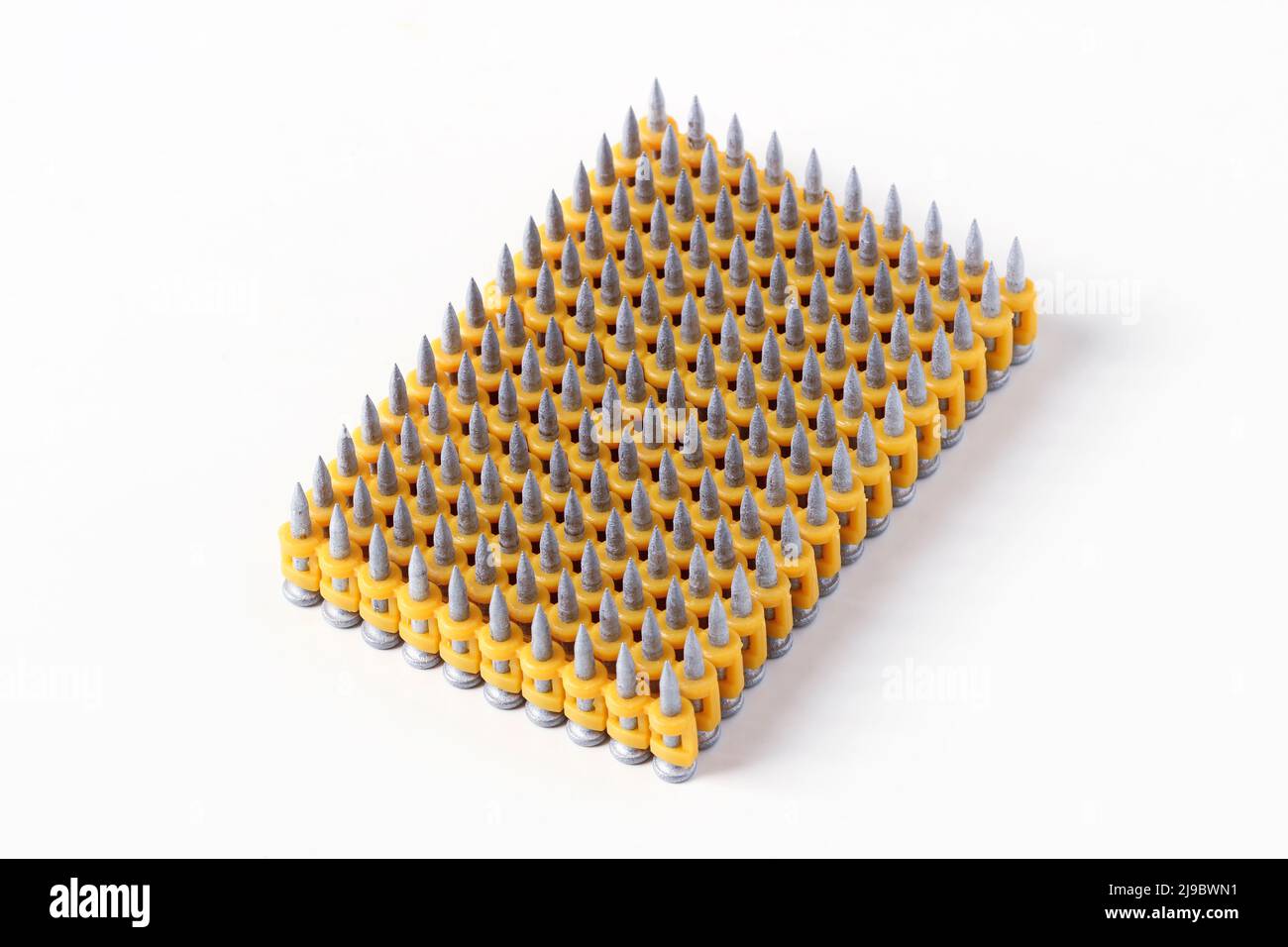 Construction nails for a pistol in plastic clips isolated on a white