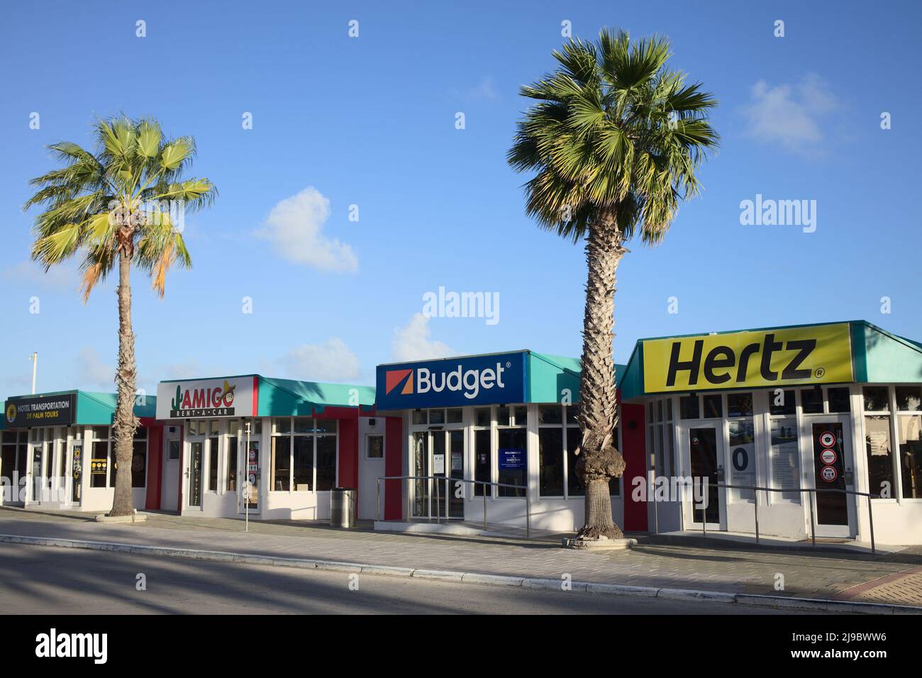 ORANJESTAD, ARUBA - DECEMBER 21, 2020: Car rental offices in the morning outside the Queen Beatrix International Airport in Oranjestad, Aruba Stock Photo