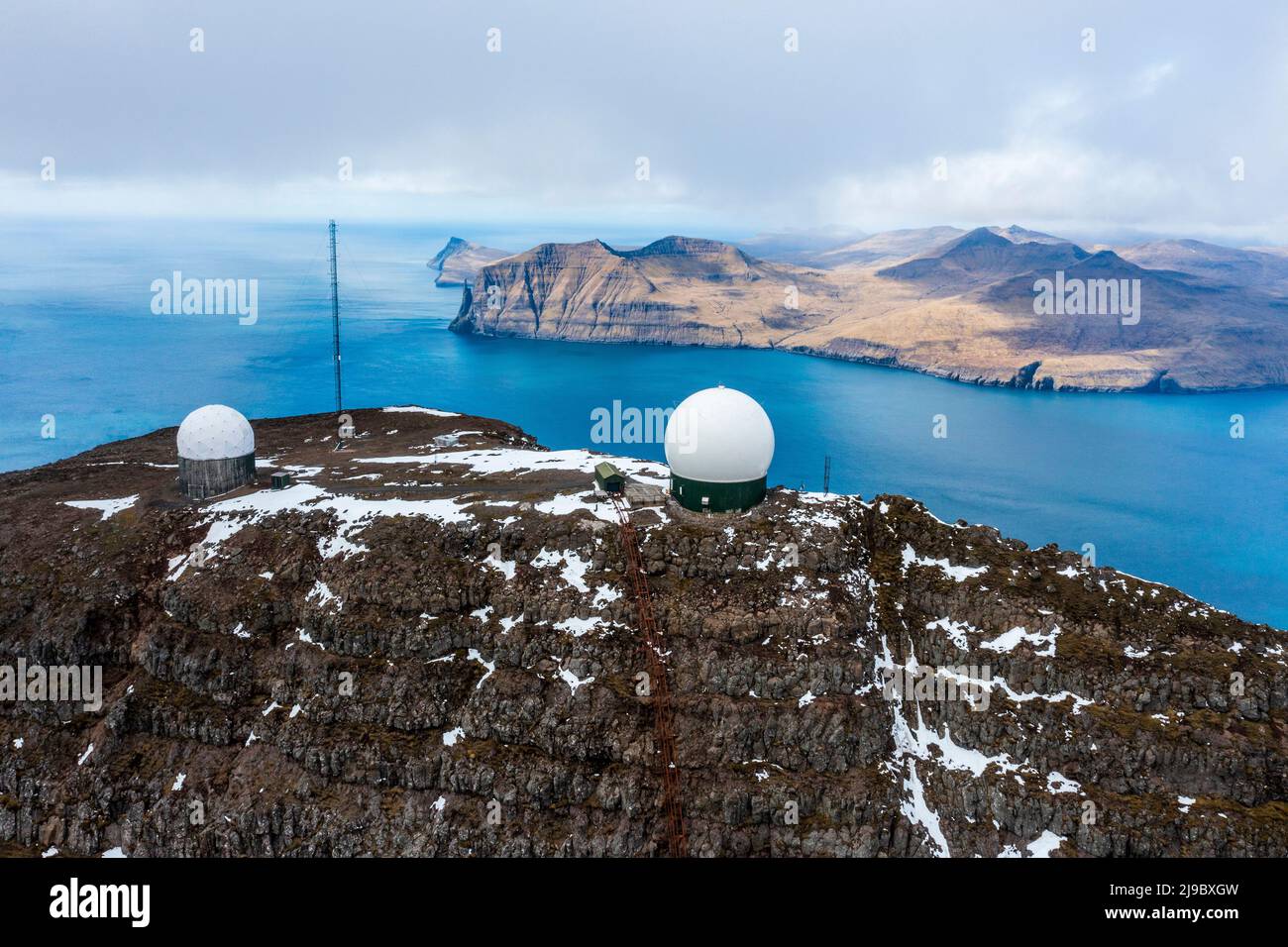 Other-worldly white globes on the rugged rock are the remnants of a Cold War military base. Stock Photo