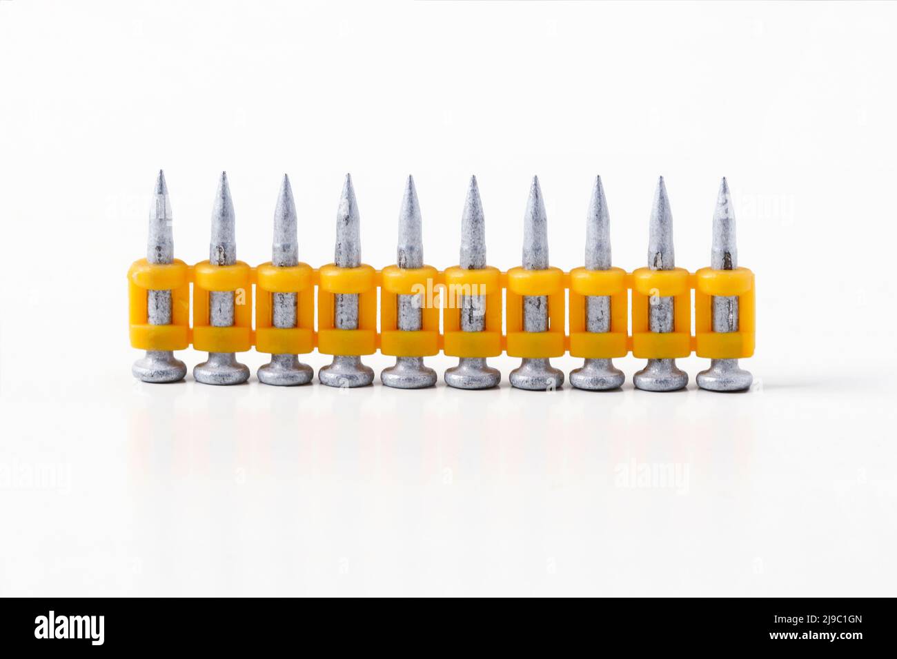 Construction nails for a pistol in plastic clips isolated on a white