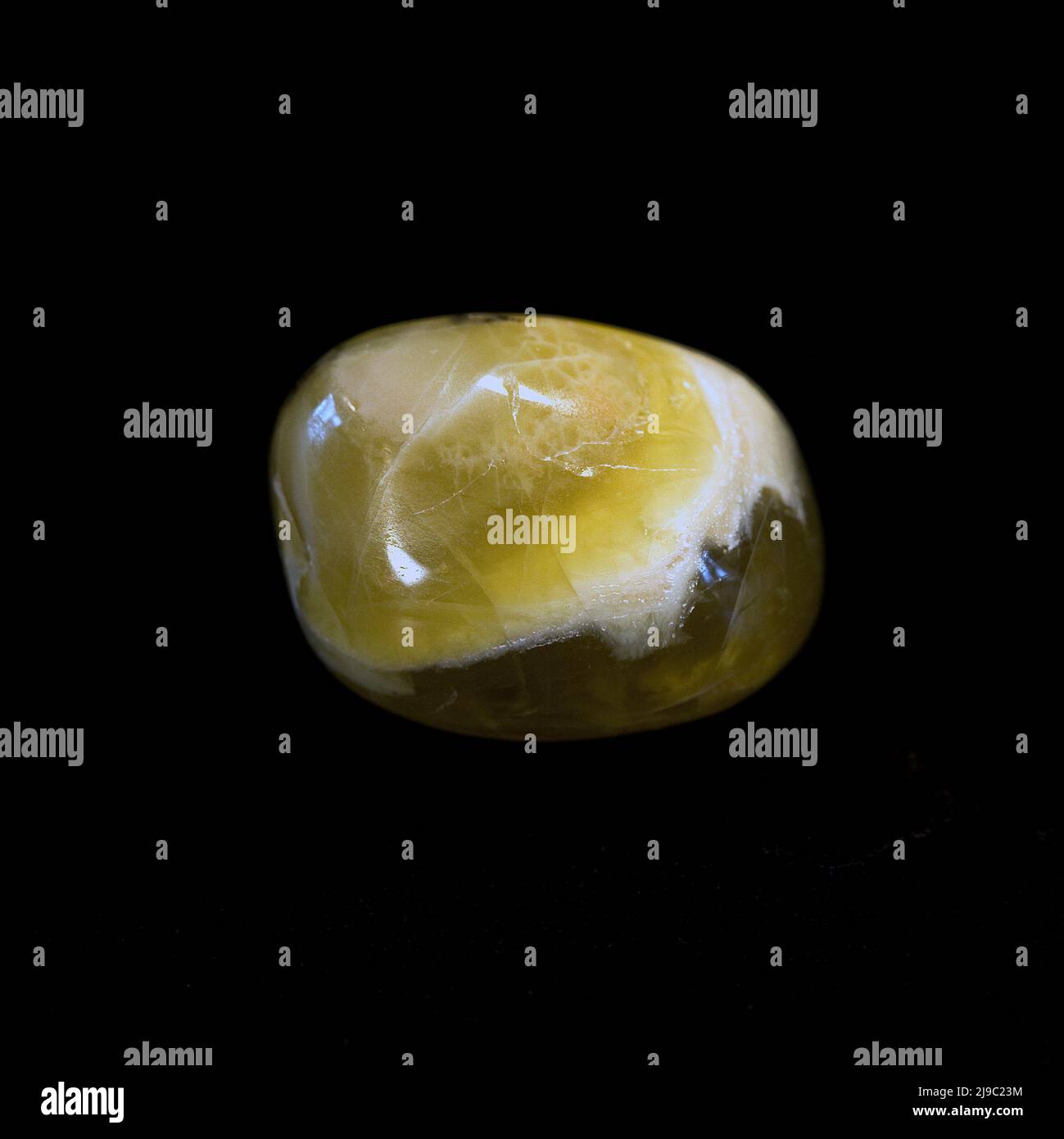 Macro close up colour photograph of a polished 'Yellow Opal' a semi