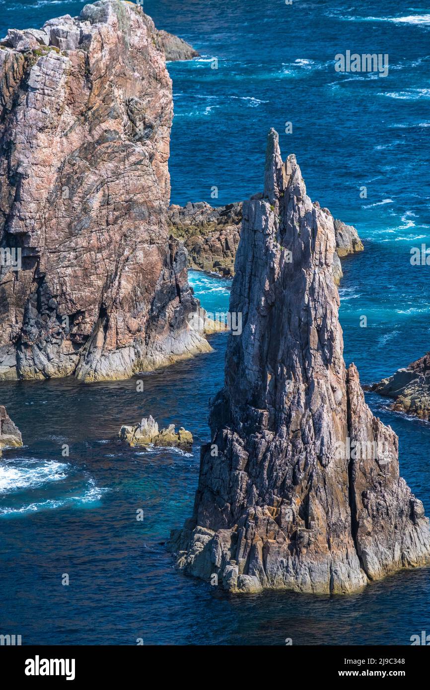 Outcrops of rock rise from the brilliant blue sea. Stock Photo