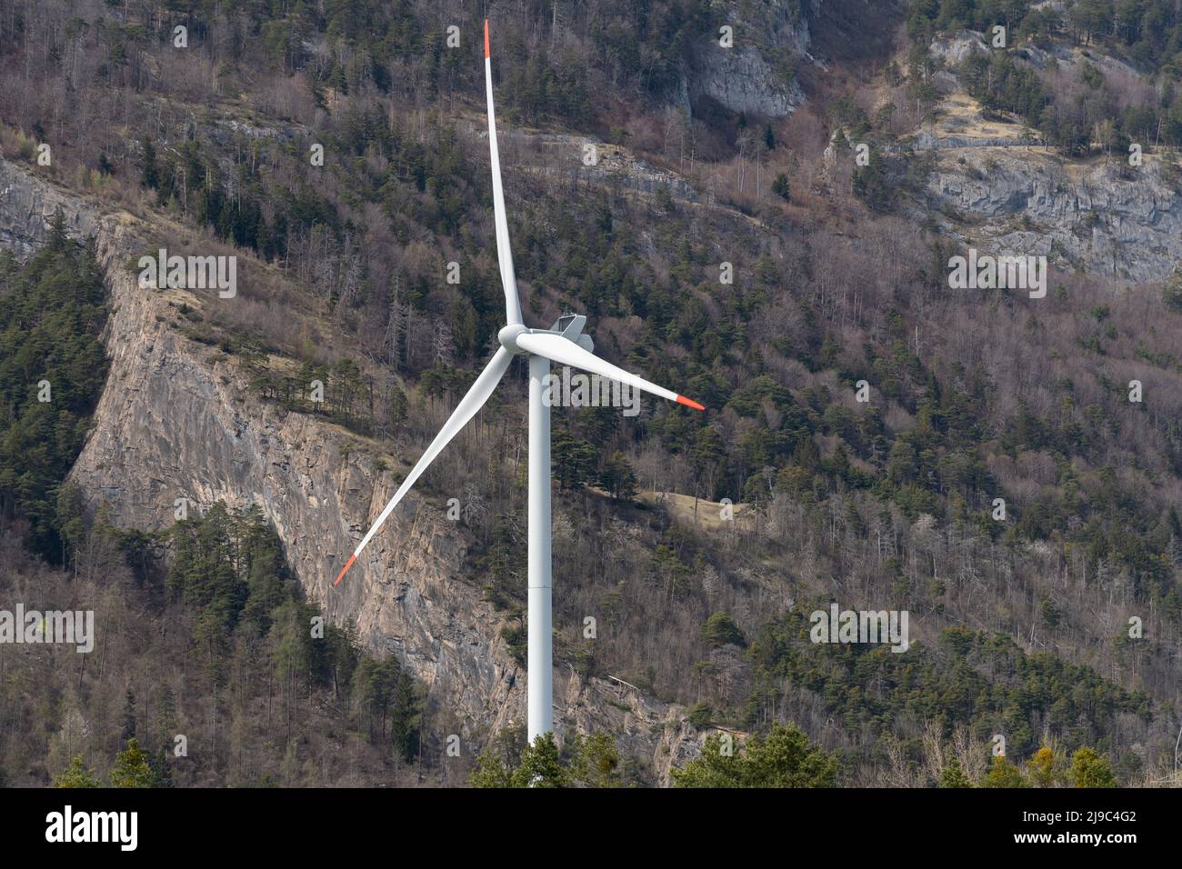 Chur, Switzerland, April 11, 2022 Wind turbine in the alps in spring time Stock Photo