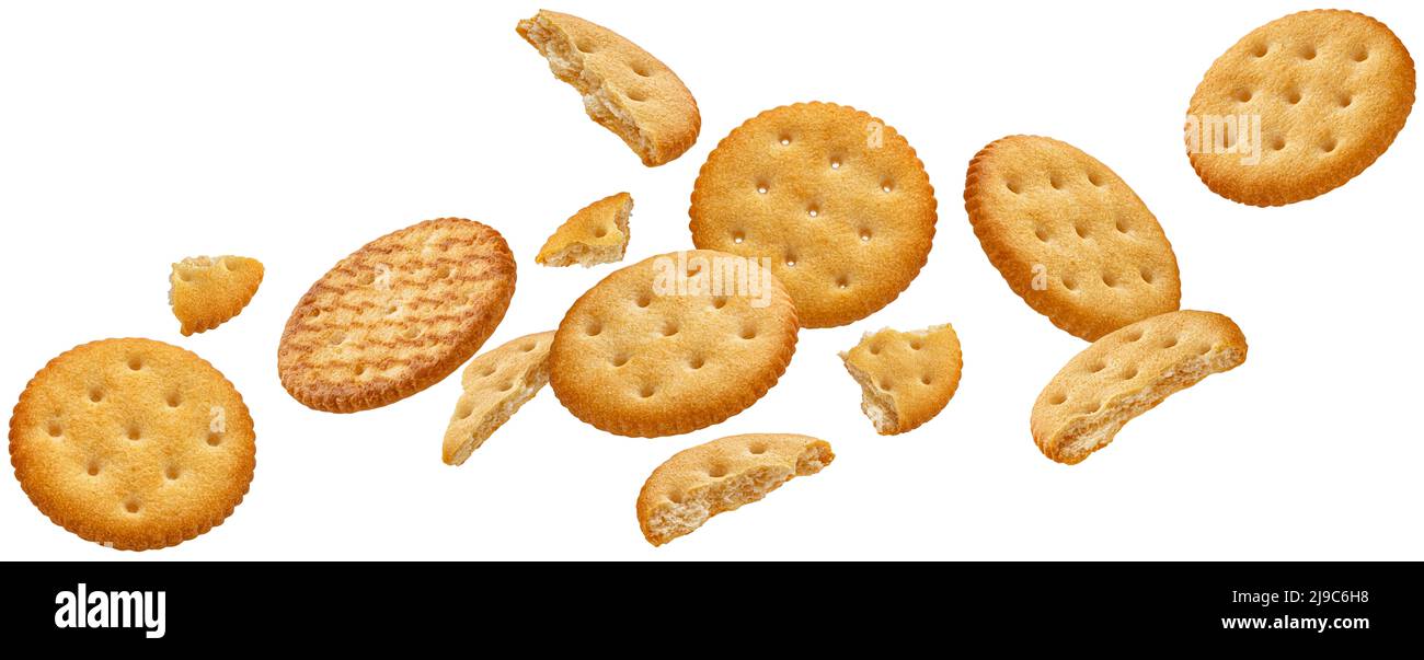Falling round cheese crackers isolated on white background Stock Photo