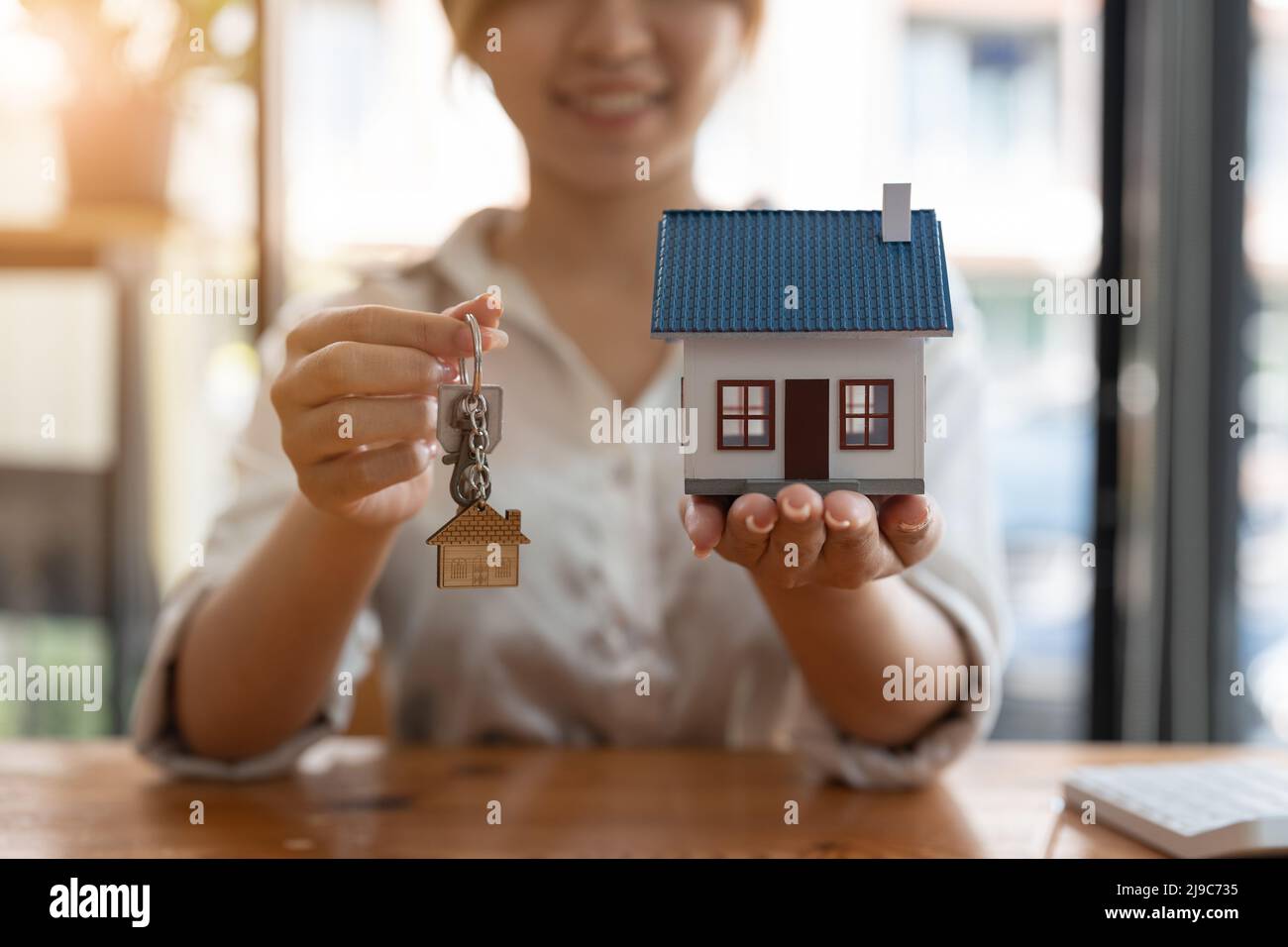 Real estate agent handing over keys to home Stock Photo Alamy