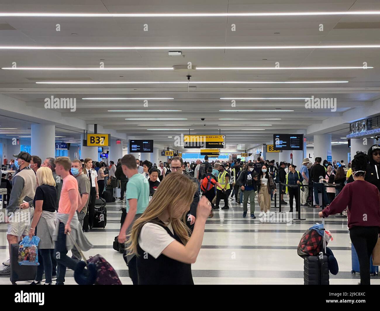 Passengers walk through Terminal 4 at JFK Airport in New York on May 20