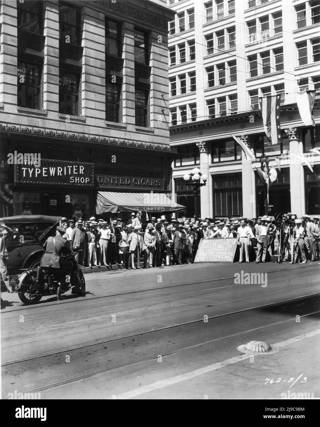Movie Crew On Set Location candid filming at corner of 6th and Spring Streets in Downtown Los Angeles at 5.30 a.m. for GEORGE BANCROFT in THE MIGHTY 1929 director JOHN CROMWELL Paramount Pictures Stock Photo
