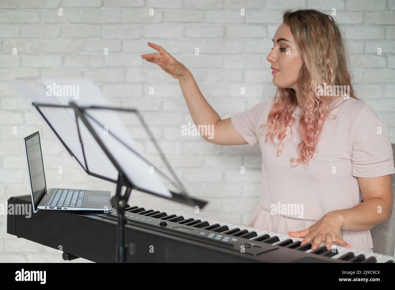 Remote music lessons. A singing teacher records the lesson on a laptop