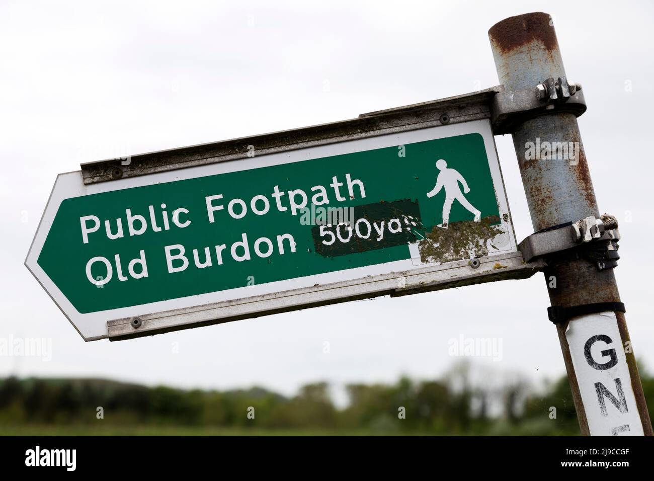 Sign pointing towards Old Burdon Village in Sunderland, England. The sign indicates that walkers should follow the footpath for 500 yards. Stock Photo