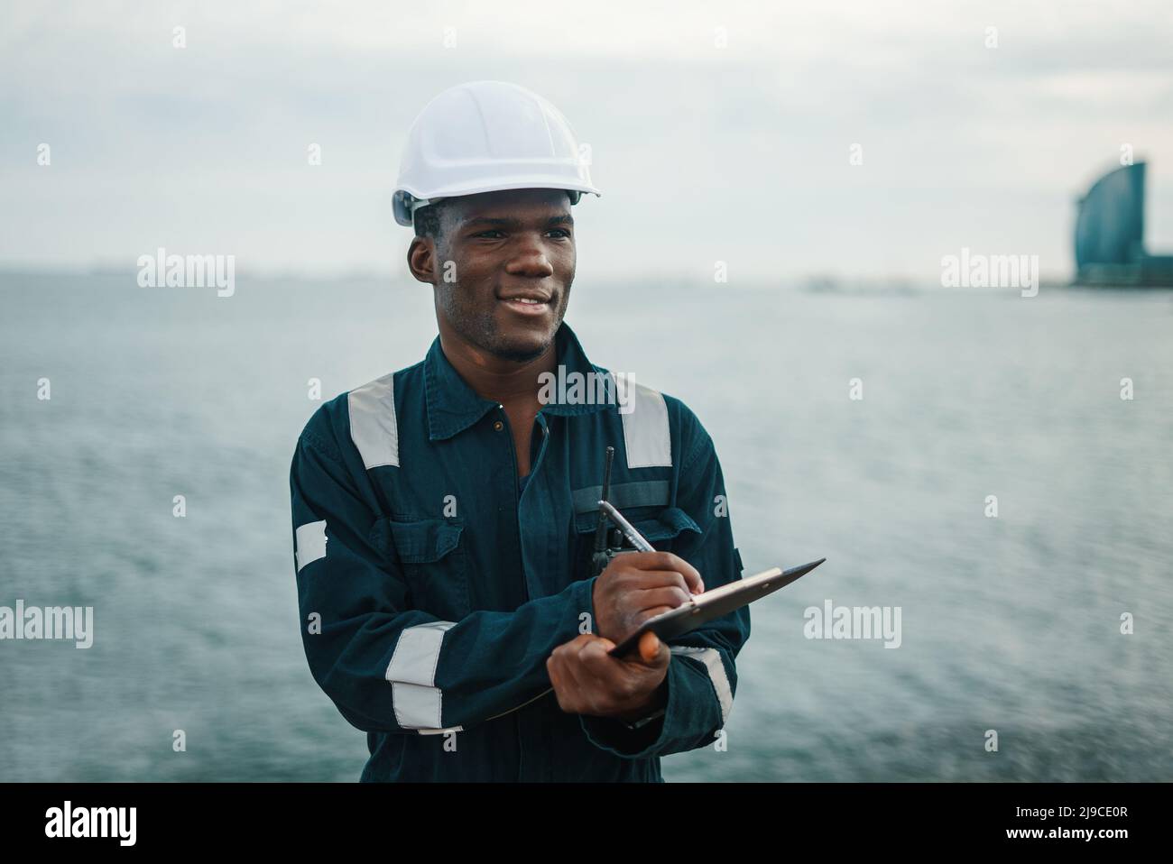 Thoughtful seaman making notes and looking away Stock Photo