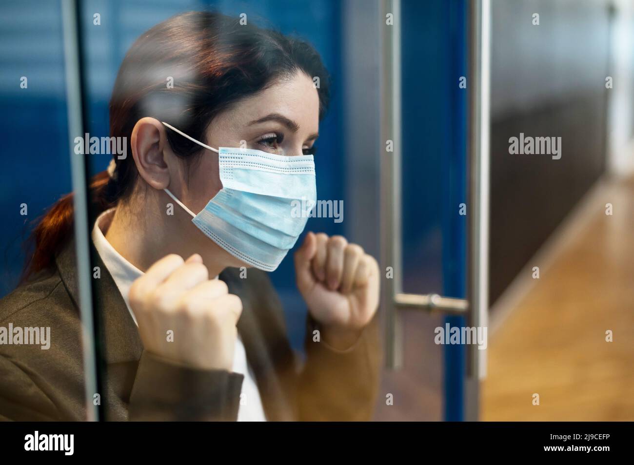 A girl in a medical mask is isolated due to biological hazard. The ...