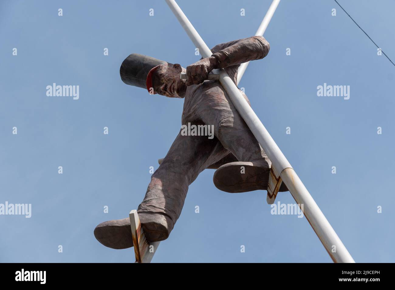 Chur, Switzerland, April 11, 2022 Sculpture of a man walking on stilts in the city center Stock Photo