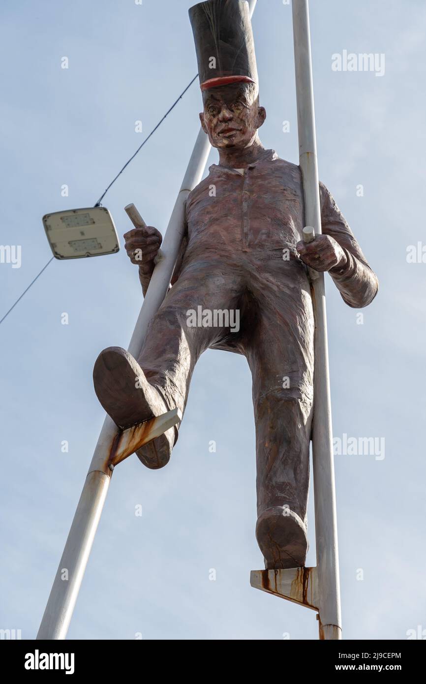 Chur, Switzerland, April 11, 2022 Sculpture of a man walking on stilts
