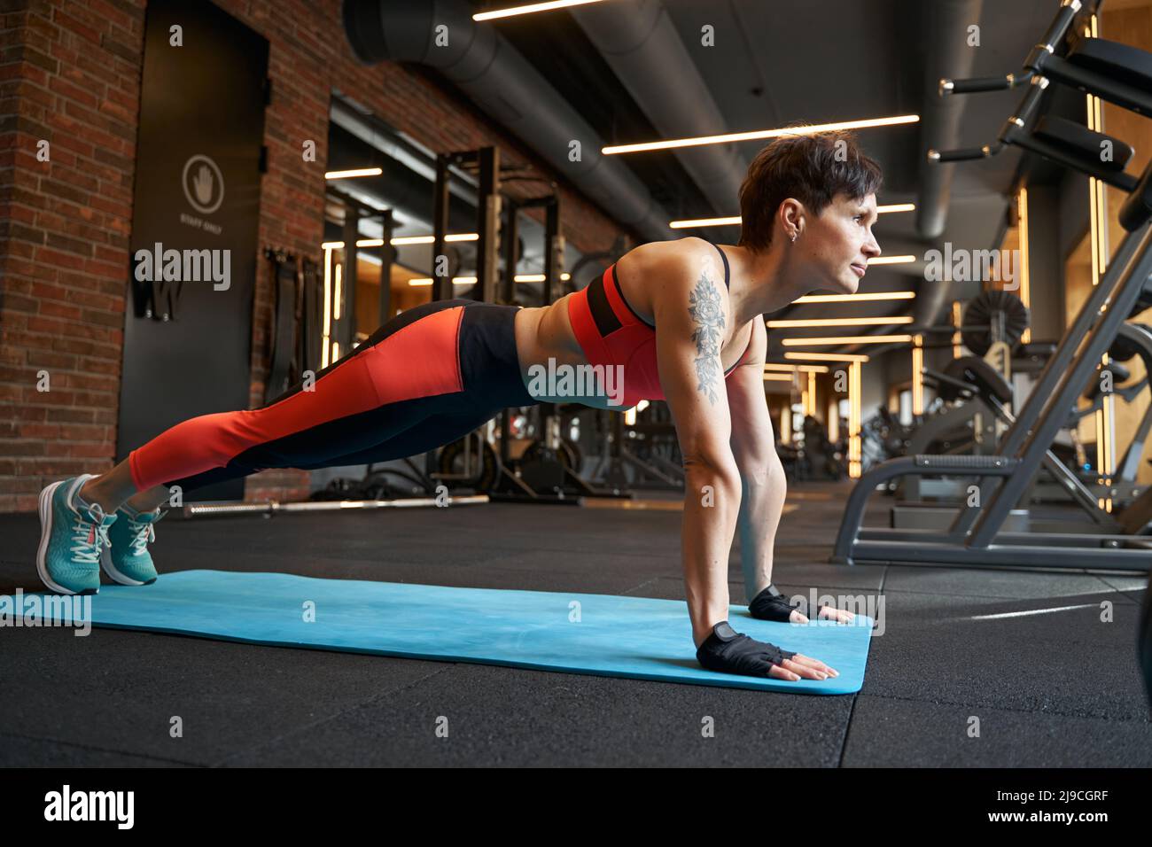 Fit woman doing core exercise at gym Stock Photo