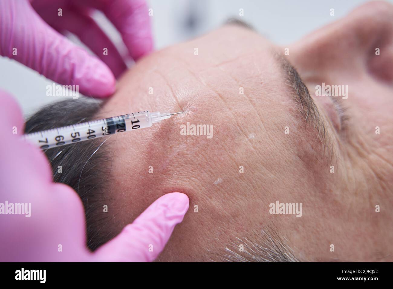 Doctor injecting adult male hi-res stock photography and images - Alamy