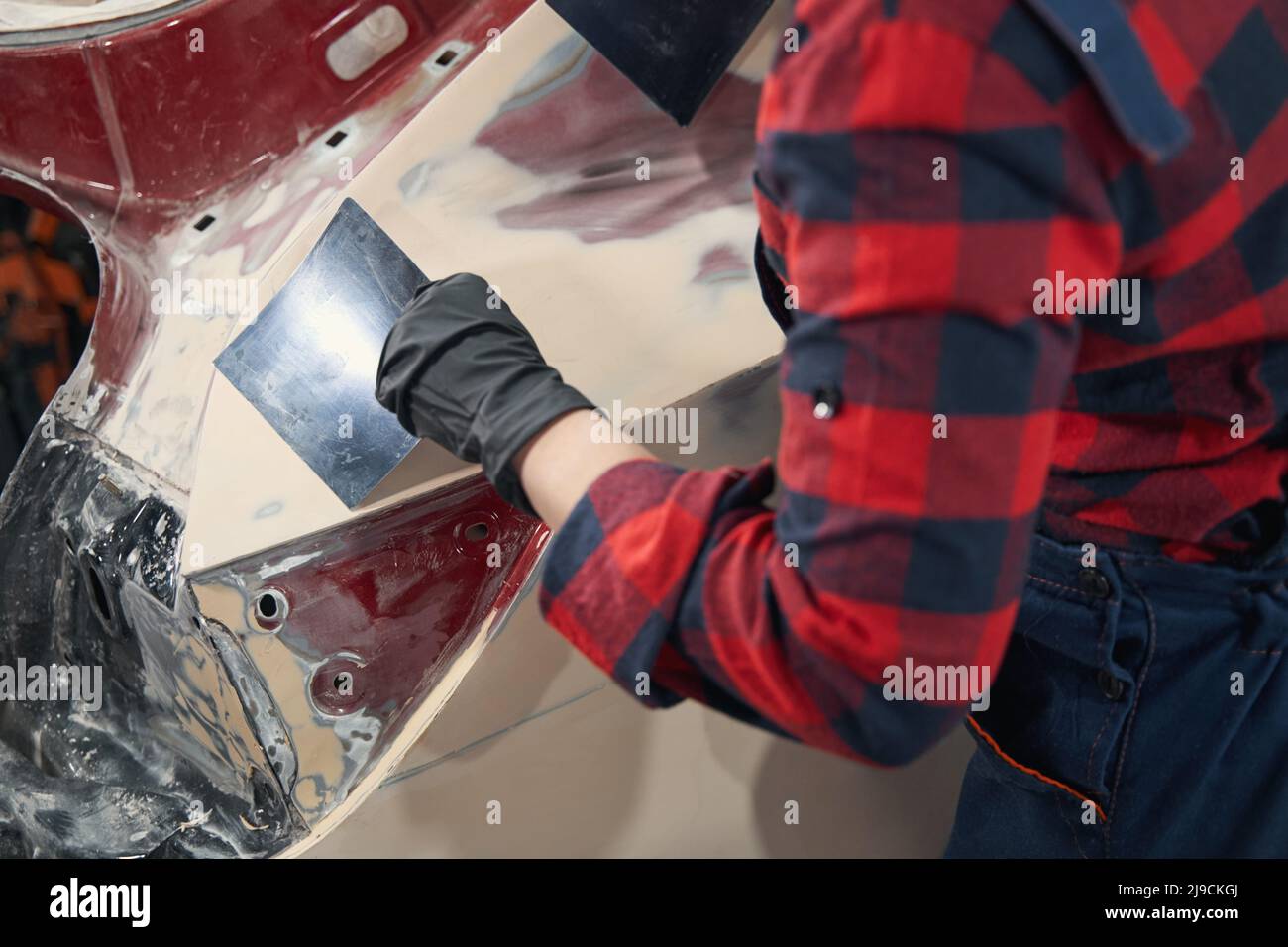 Close up of female master putting primer on car Stock Photo Alamy