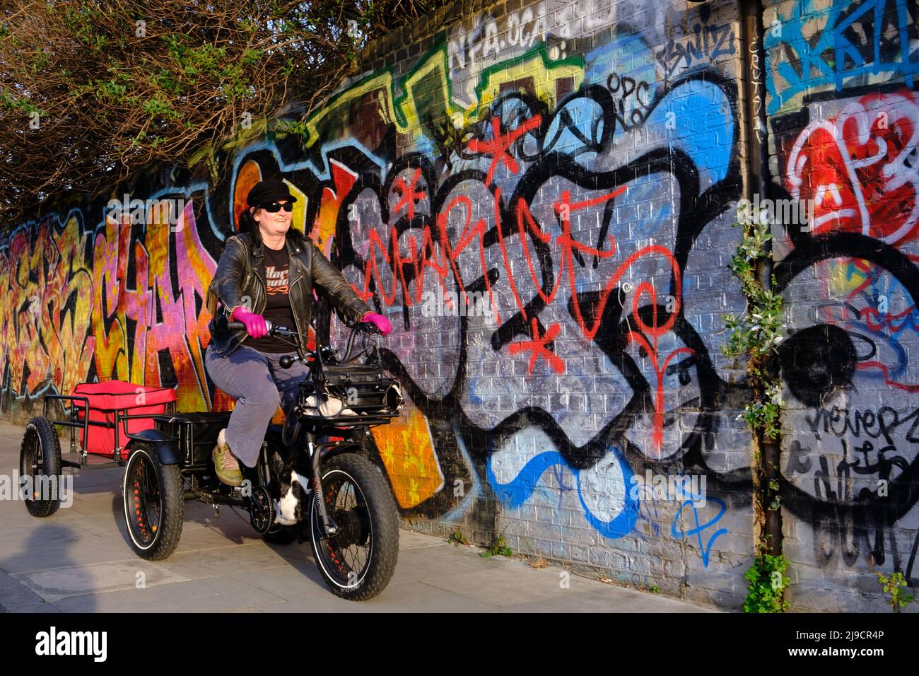 Lady on tricycle,  Hackney Wick, London, UK Stock Photo