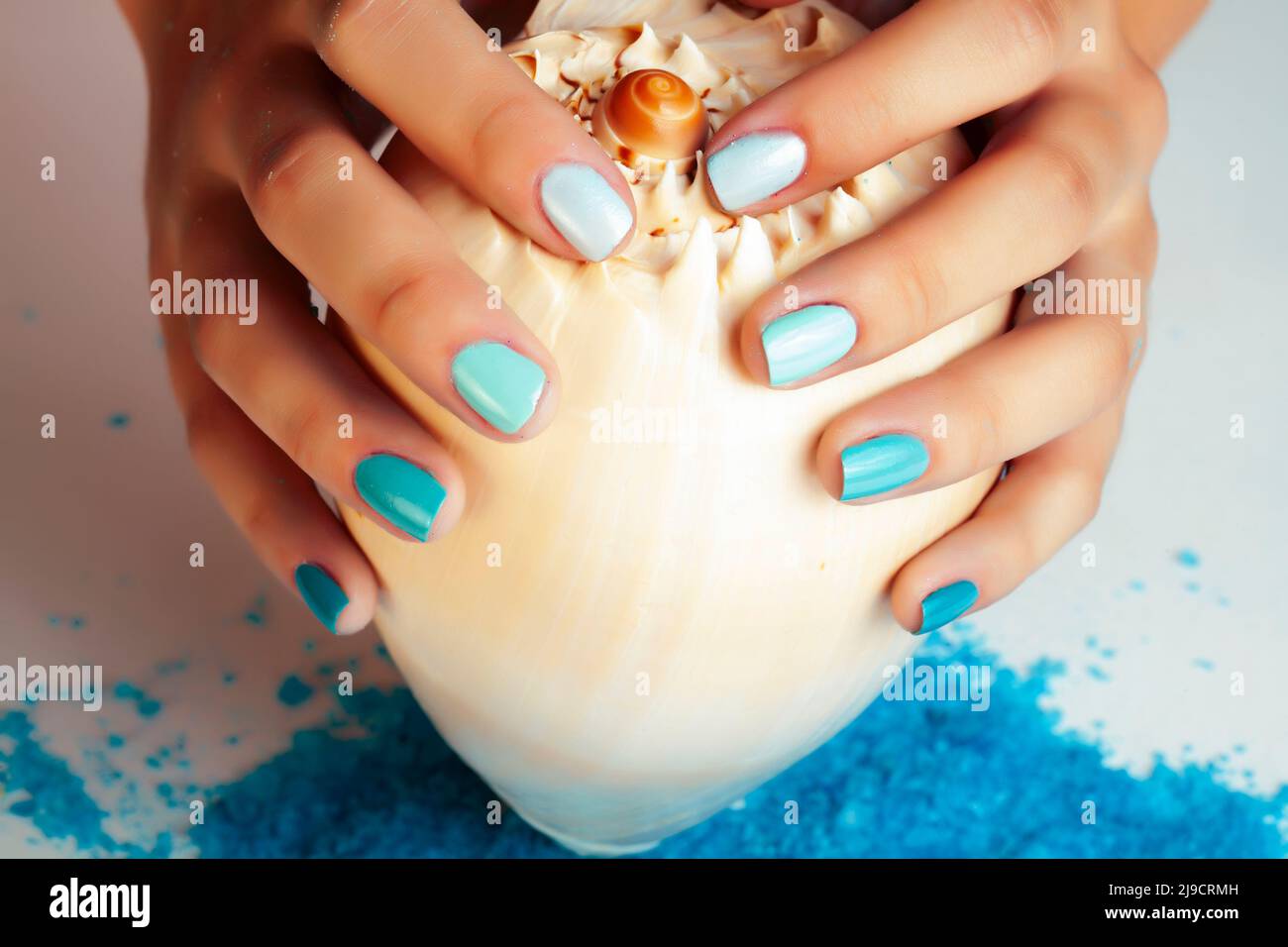 manicure with blue nails and seasalt close up like heart, love for summer  Stock Photo - Alamy