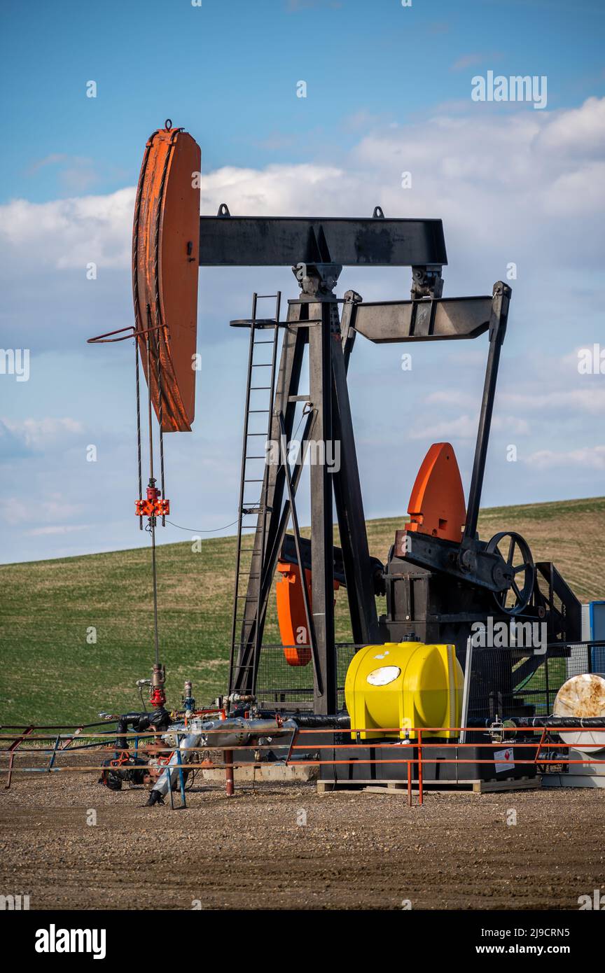 Pumpjacks working in the oil fields of Alberta on a spring day Stock