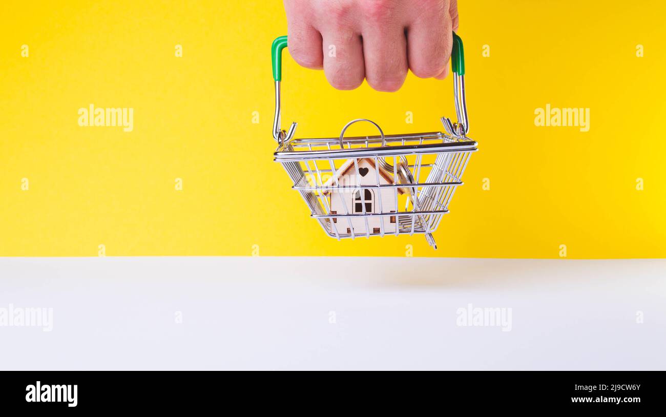 Acquisition of housing. Buying a house. Getting the keys to the apartment. Keys in the grocery cart. Mortgage lending for the population. Stock Photo