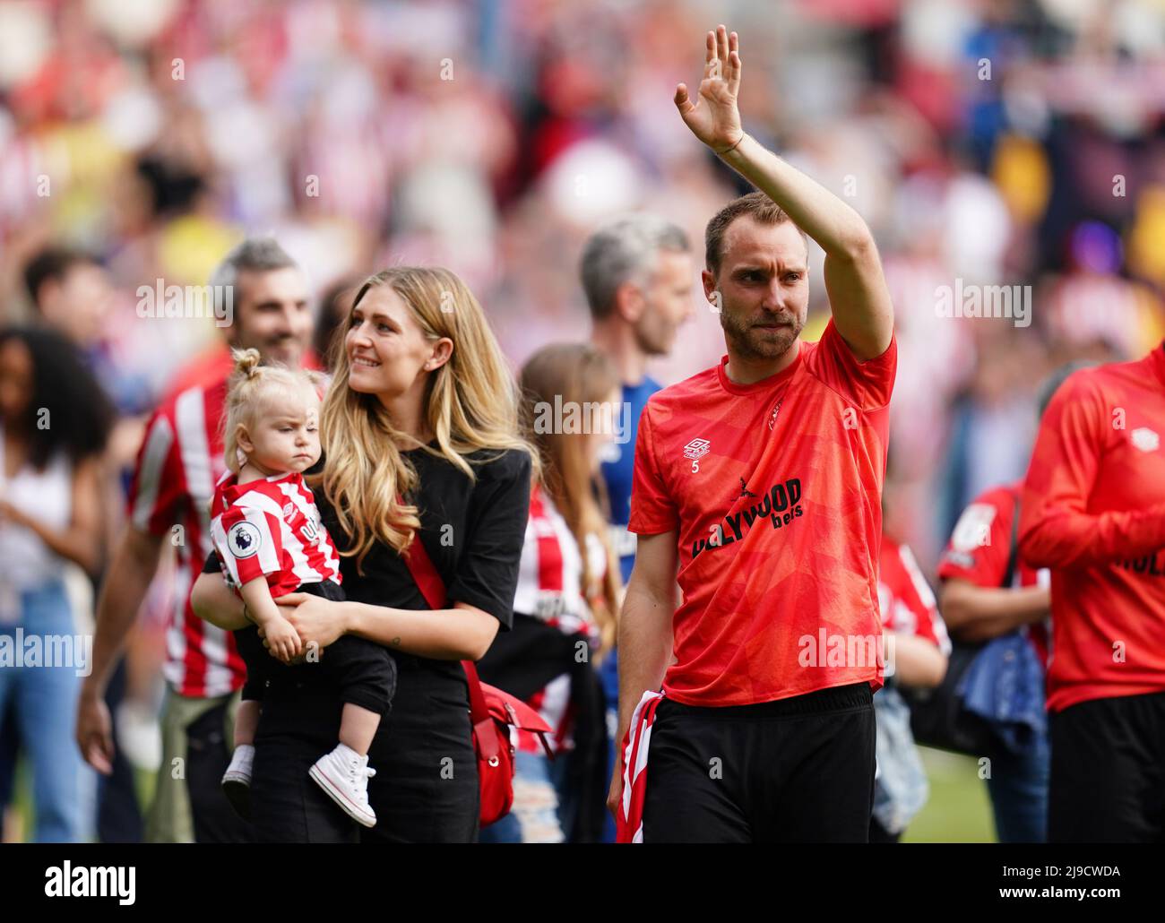 Brentford's Christian Eriksen waves to the fans during a lap on honour with partner Sabrina Kvist Jensen and their daughter after the Premier League match at The Brentford Community Stadium, London. Picture date: Sunday May 22, 2022. Stock Photo