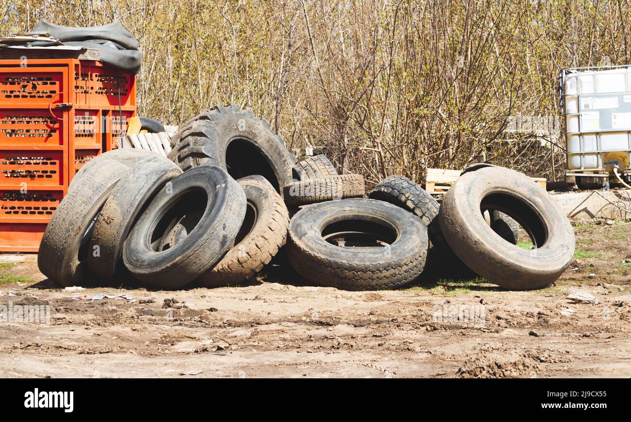 Changing car tires. Old rubber tires in the trash. Car dump. Garbage