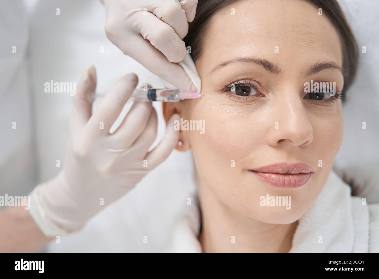 Woman receiving rejuvenating face lifting injection in clinic Stock ...