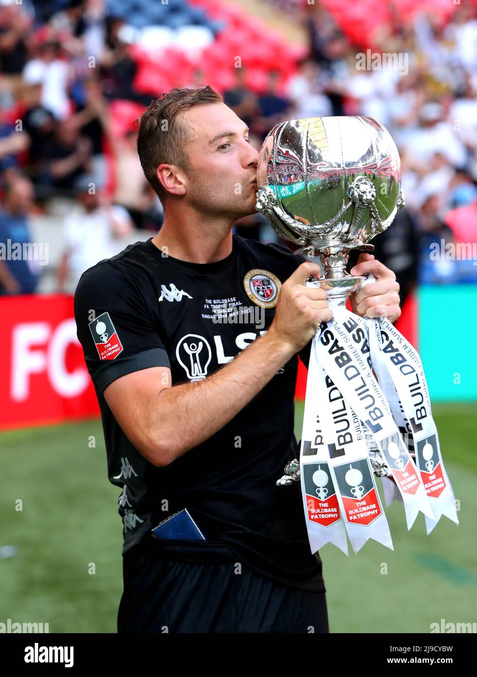 Bromley's Michael Cheek celebrates with the trophy after winning the ...