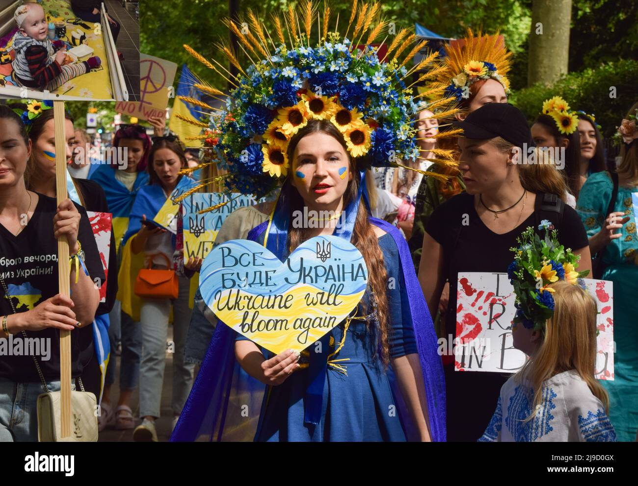 London, England, UK. 22nd May, 2022. A protester wearing an elaborate traditional flower headdress marches past Hyde Park. Crowds marched from Hyde Park to the Russian Embassy in London calling on the international community to help save the children in Ukraine and in protest against the atrocities reportedly committed by Russian forces. (Credit Image: © Vuk Valcic/ZUMA Press Wire) Stock Photo
