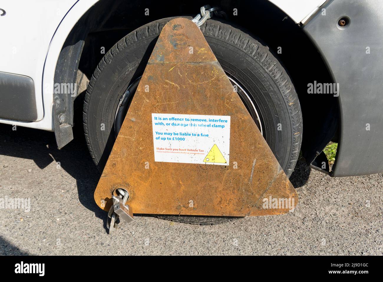 Warminster, Wiltshire, UK - May 17 2022: A wheel clamp on an untaxed vehicle Stock Photo