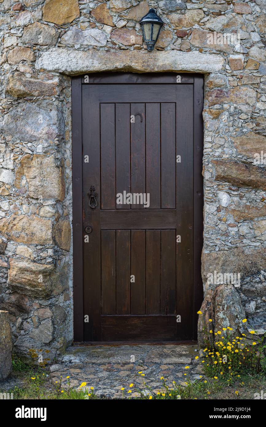 Ancient wooden door in stone wall Stock Photo - Alamy