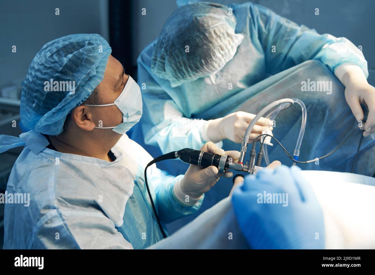 Laparoscopic instrument in hand of male surgeon during abdomen