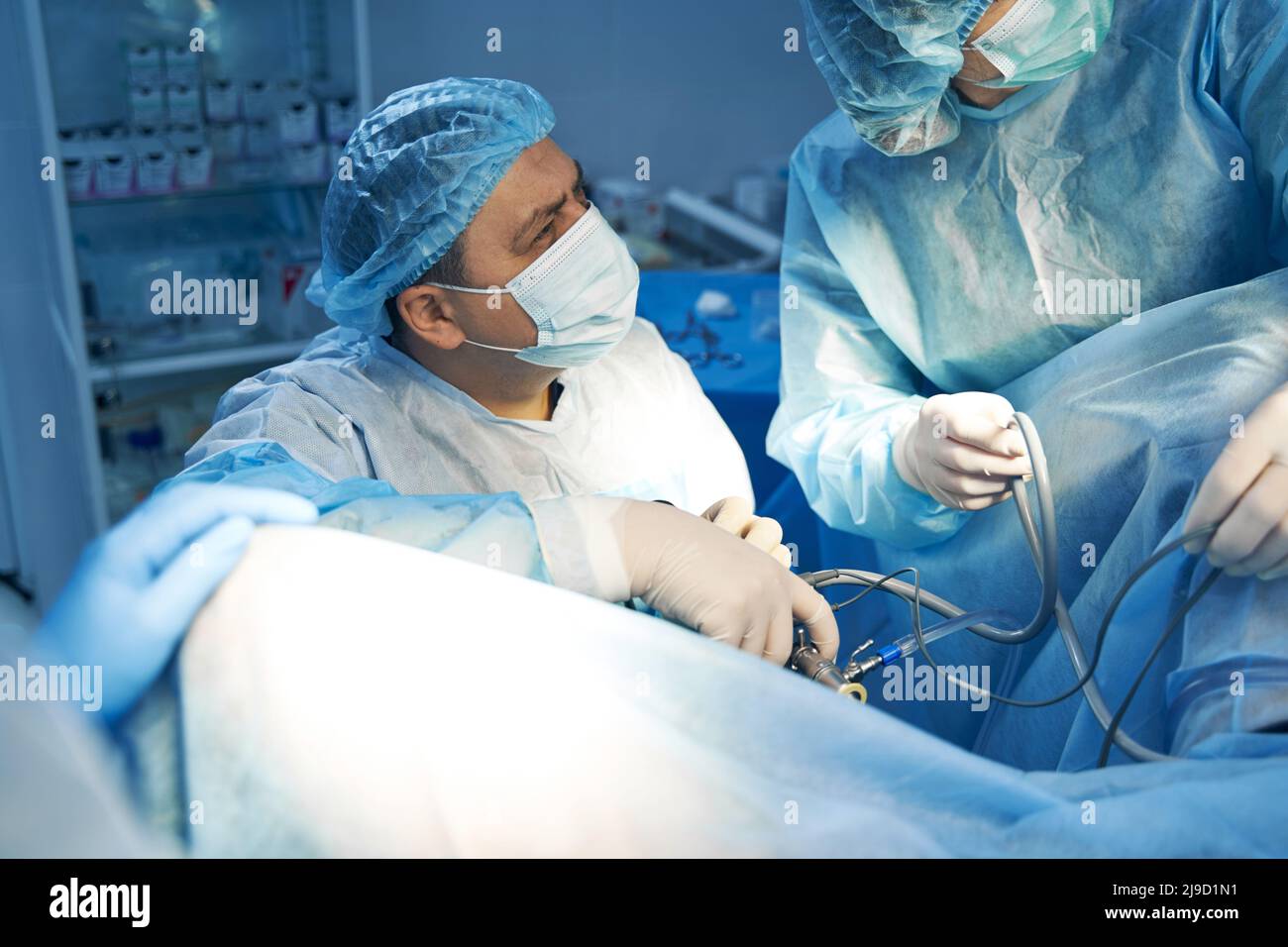 Surgeon performing minimally invasive surgery with laparoscope Stock Photo