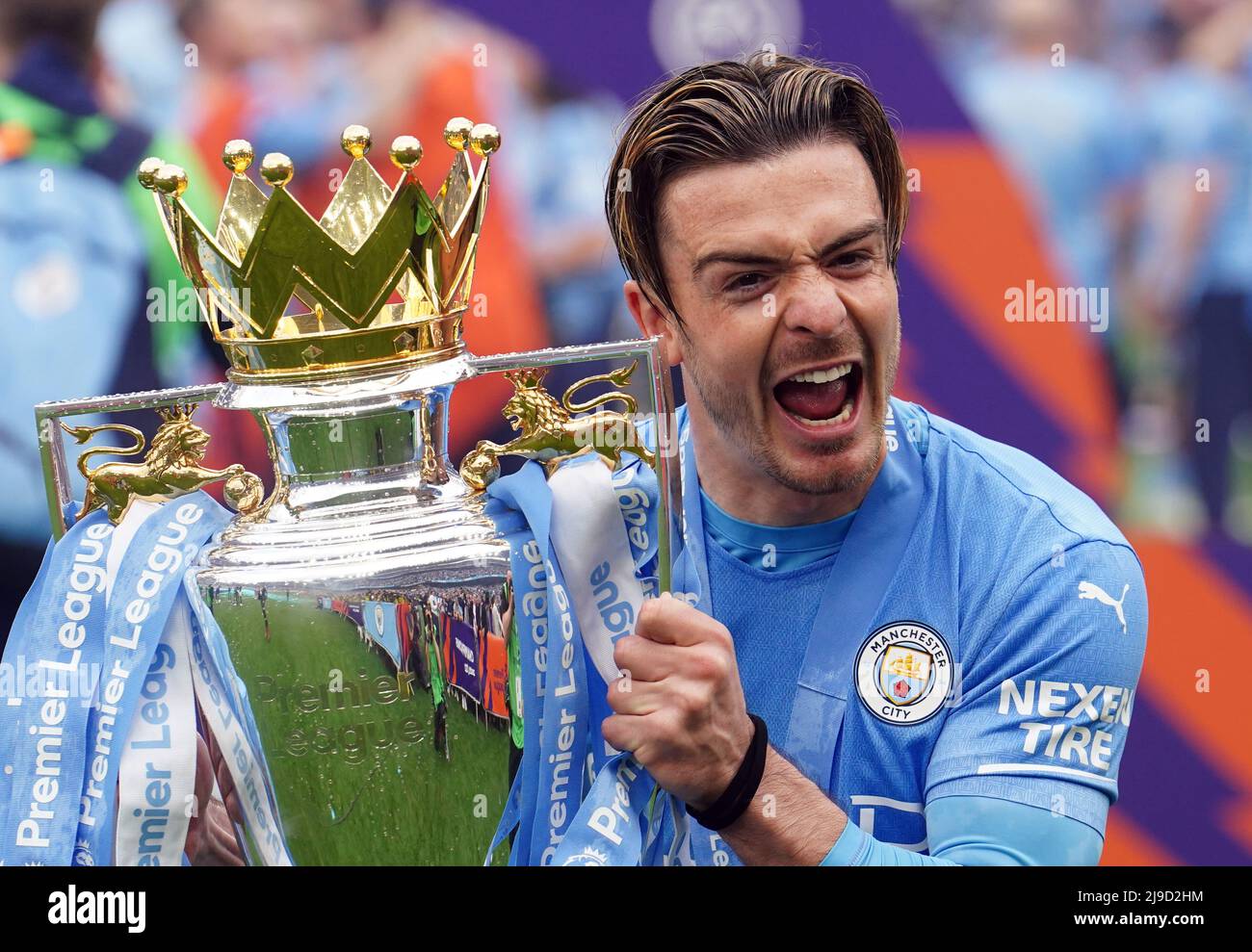 Manchester City's Jack Grealish lifts the Premier League trophy following the the Premier League match at The Etihad Stadium, Manchester. Picture date: Sunday May 22, 2022. Stock Photo