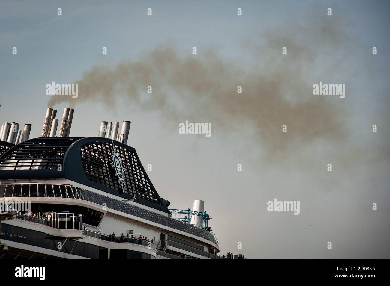 MSC Meraviglia cruise smokestacks give off smoke shortly before leaving the port of Barcelona. Sulphur oxide and nitrogen oxide emissions makes Barcelona port worst in Europe for cruise ship air pollution. Stock Photo