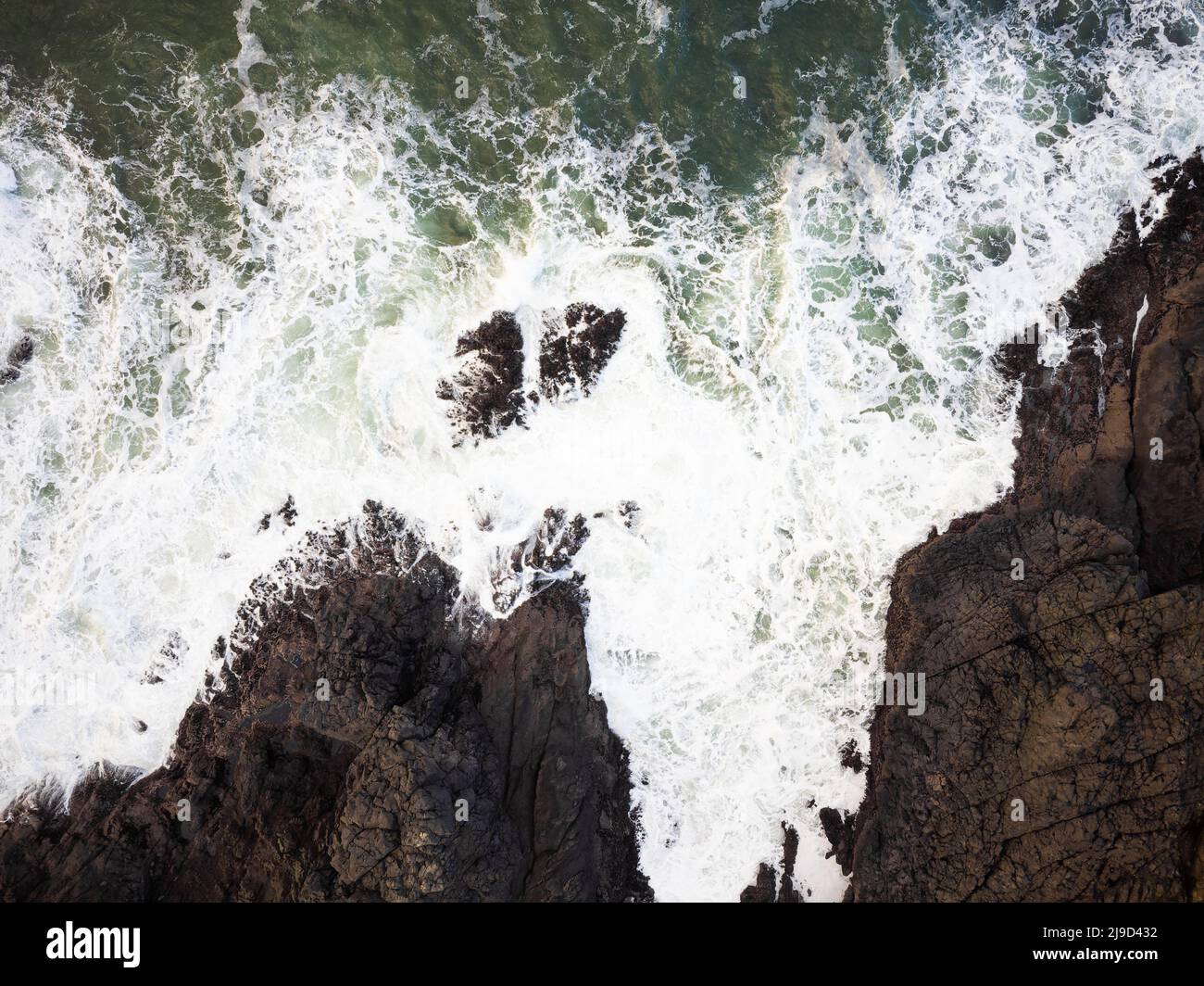 Foamy waves hit rocks on hi-res stock photography and images - Alamy