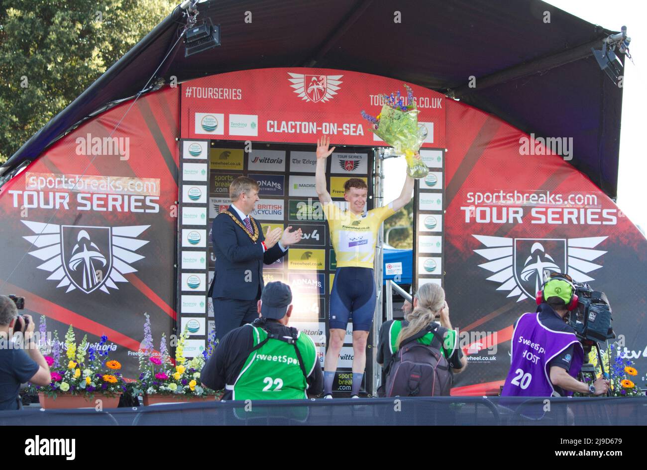 Cycling event Tour Series 2022 round 5 at Clacton-on-sea, Essex. Matthew Bostock of team Wiv SunGod on the podium after winning the men's race. Stock Photo