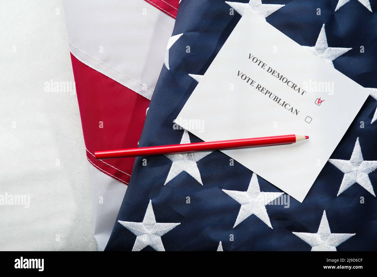 Voting ballot, pencil and American flag. Elections, the right to vote, freedom of choice, independence, civic duty. Close-up. There are no people in t Stock Photo